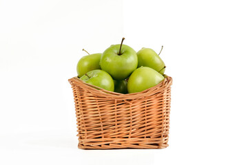 green apples in a wicker basket isolate