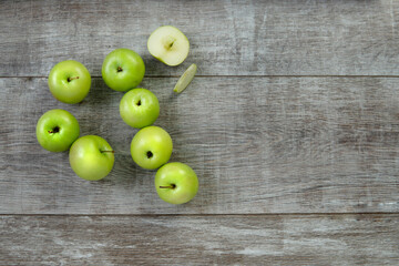 green apples and slice on a wooden table