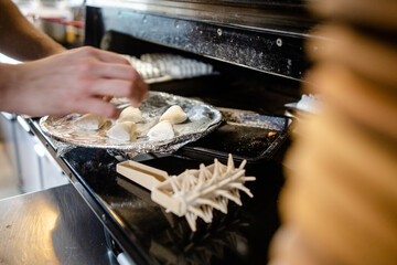 Garlic dough balls being put in the oven