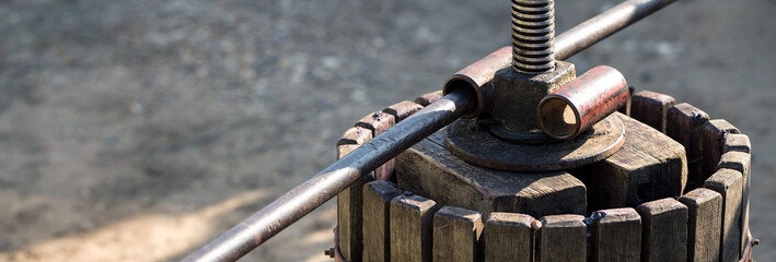 Winepress with red must and helical screw. Production of traditional Italian wines, crushing of grapes.
