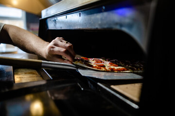 Fresh flatbread pizza being stone baked - pepperoni, cheese and tomato sauce