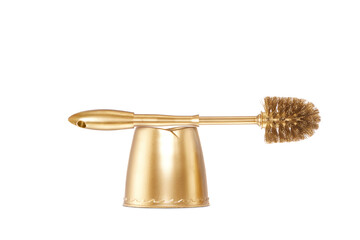 Close up view of gold toilet brush on white back