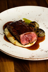 rare cooked beef fillet on a bed of mash