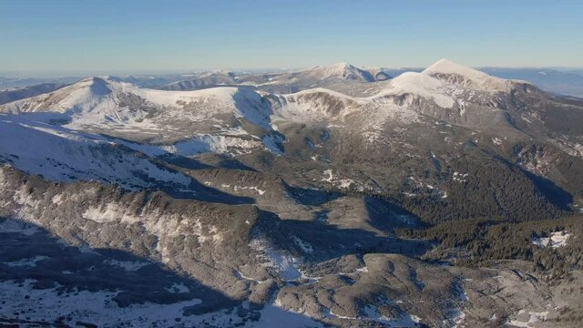 Aerial view of winter mountains. Mount Hoverla, Petros. Snow-capped peaks of the Carpathians on a sunny day.