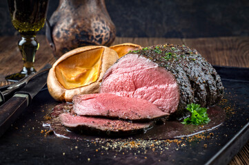 Traditional English venison roast with Yorkshire pudding and spicy sauce served as top view on a...