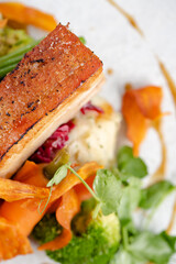 Roasted pork belly with potatoes and seasonal vegetables