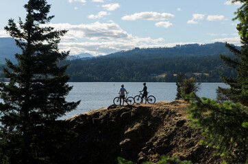 A young couple enjoy a view of the Columbia River while biking in OR.