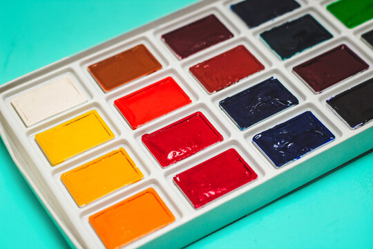 Professional watercolor paints in cuvettes. Multi-colored paints for artists.