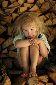 Image of a grimy child sitting on the wood.