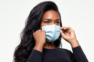 African-American woman adjust her mask for a proper fit 0335