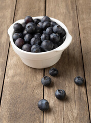 Blueberries on a bowl over wooden table