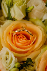 wedding rings close up on yellow roses