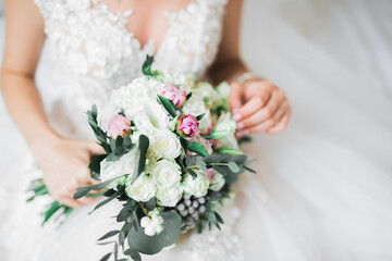 Bride holding big and beautiful wedding bouquet with flowers