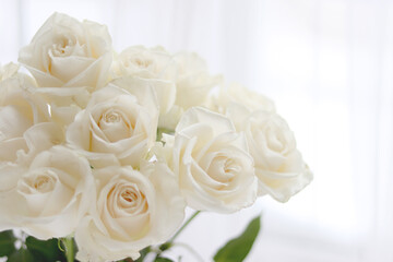 Fresh white roses, wedding, and holiday arrangements. Valentine`s Day and holiday background.