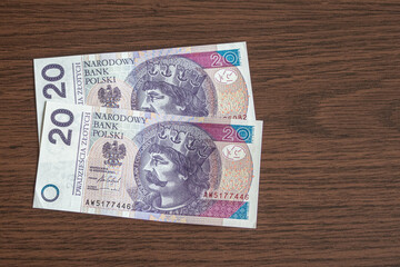 20 zloty bill of Poland on a wooden table.