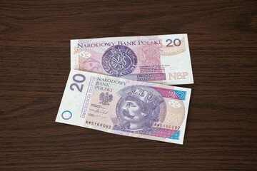 20 zloty bill of Poland on a wooden table.