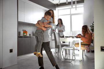Cheerful happy family is having time at cozy home's dining room