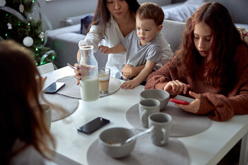 Cheerful happy family is having time at cozy home's dining room
