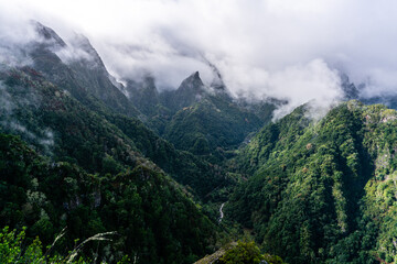 Fototapeta na wymiar Green cloud-covered mountain peaks on Madeira Island