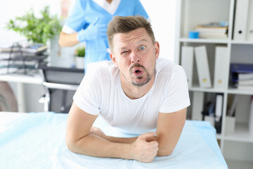 Surprised man undergoes medical examination by proctologist. Bowel disease in man concept
