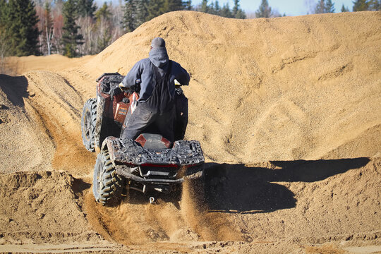 The back of a quader going up a gravel hill