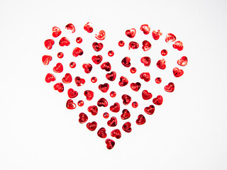 Heart shape made of hearts objects and red crystals on white background, happy valentine's day, mother's day, flat lay, top view