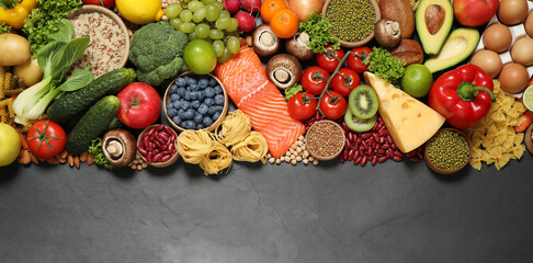 Different products on black table, top view with space for text. Healthy food and balanced diet