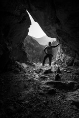 person in the cave - obrazy, fototapety, plakaty