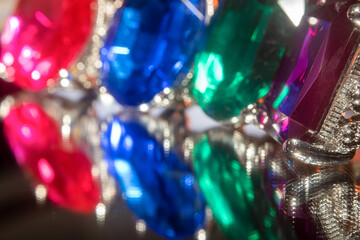 colorful sparkly gemstones reflected on a mirror