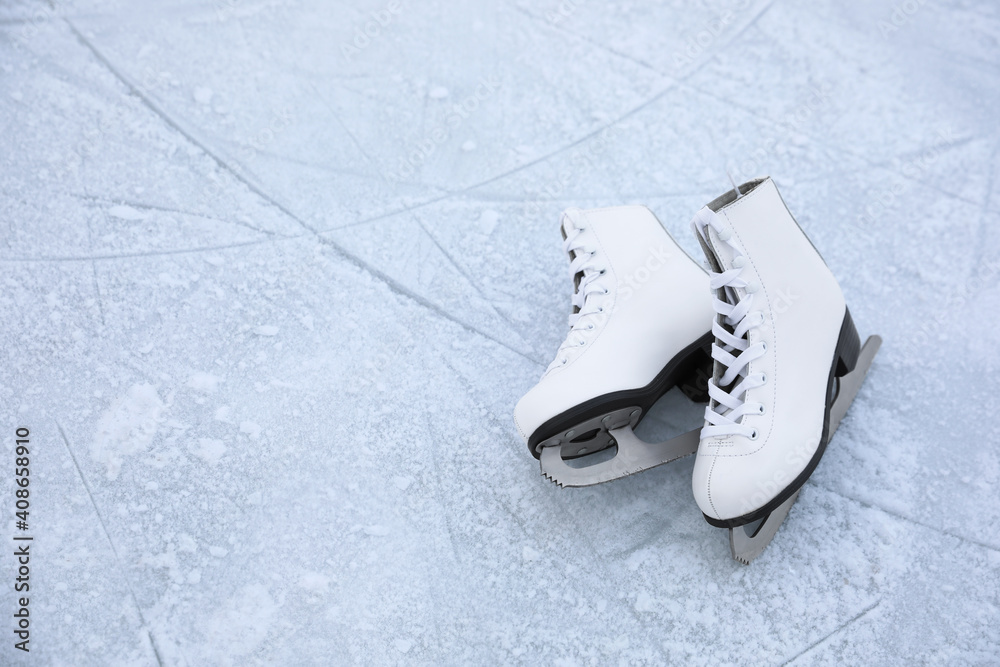 Canvas Prints Figure skates with laces on ice, space for text. Winter outdoor activities