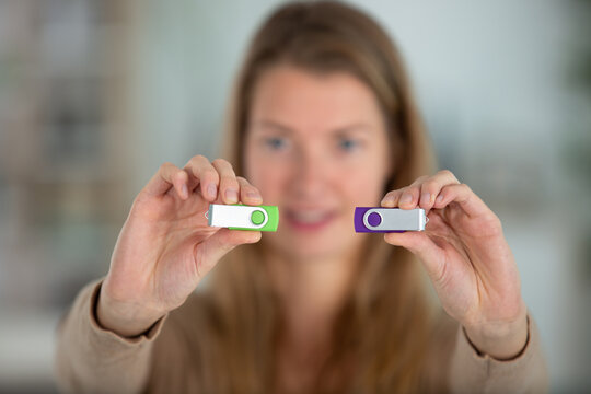 woman holding two usb keys focus on a foreground