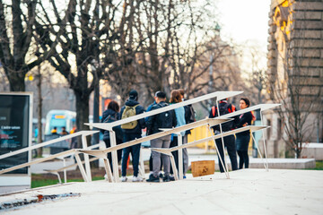 Fototapeta premium Defocused view of teenagers view through the metallic stair railing decorations in the city