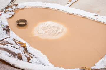 Pile of mined salt in middle of salt field, Salineras de Maras, Sacred Valley, Peru
