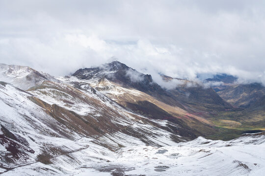 Scenic view of valley in the Andes on Rainbow Mountain trail during winter, Pitumarca, Peru