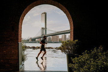Silhouette of man running against skyline.