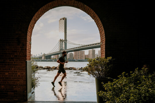 Silhouette of man running against skyline. - Powered by Adobe