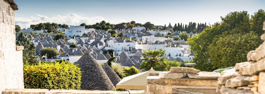 Sunshine on summer vacation in trulli town of Alberobello in Puglia, Italy
