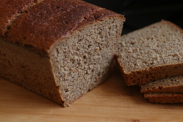 Healthy dark bread on a wooden background. Bio ingredients, homemade, for breakfast.