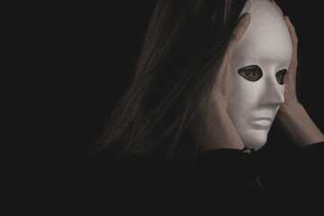 portrait of a woman in a white mask in the dark