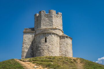 Fototapeta na wymiar Closeup on small tower like, 11th century, St. Nicholas church situated on small hill, located between Nin and Zaton in Croatia