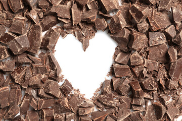 Heart made with dark chocolate crumbles on white background, top view