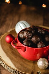 peanut butter chocolate truffles in a red bowl on a wood table