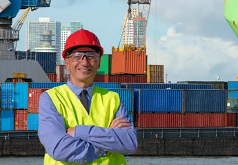 Foto op Canvas Smiling Man Standing Near Container Terminal - Container Shipping © RGtimeline