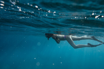 Female snorkelers on the surface of the ocean in hawaii