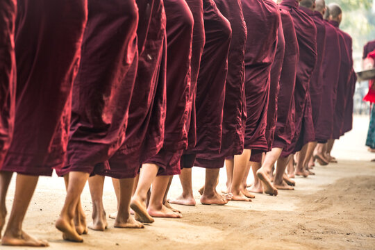 Detail shot of feet of monks waiting in queue while receiving alms, Nyaung U, Myanmar