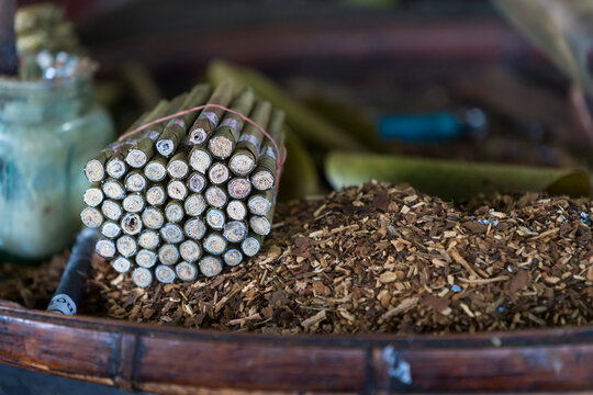 Detail shot of bundle of Burmese cigars and tobacco in workshop, Lake Inle, Myanmar