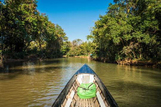 Canal on Lake Inle against blue sky seen from motorboat, Myanmar
