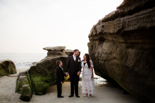 Newlyweds Posing with Nine Year Old Son on Beach in San Diego