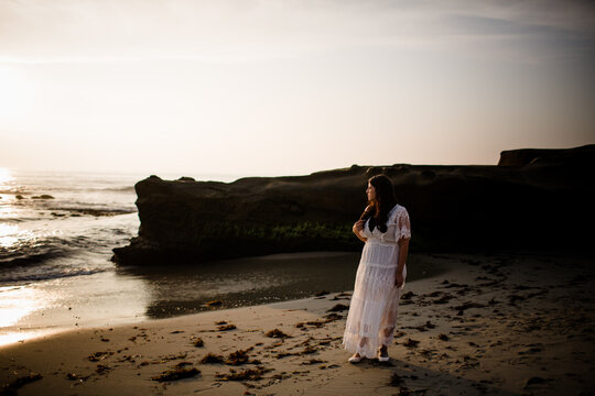 Bride Standing on Beach at Sunset in San Diego