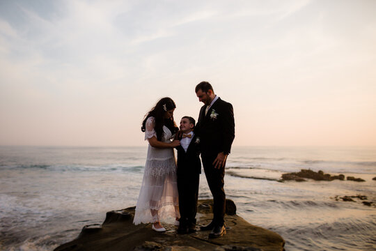 Newlyweds & Nine Year Old Son Standing on Rock at Beach in San Diego